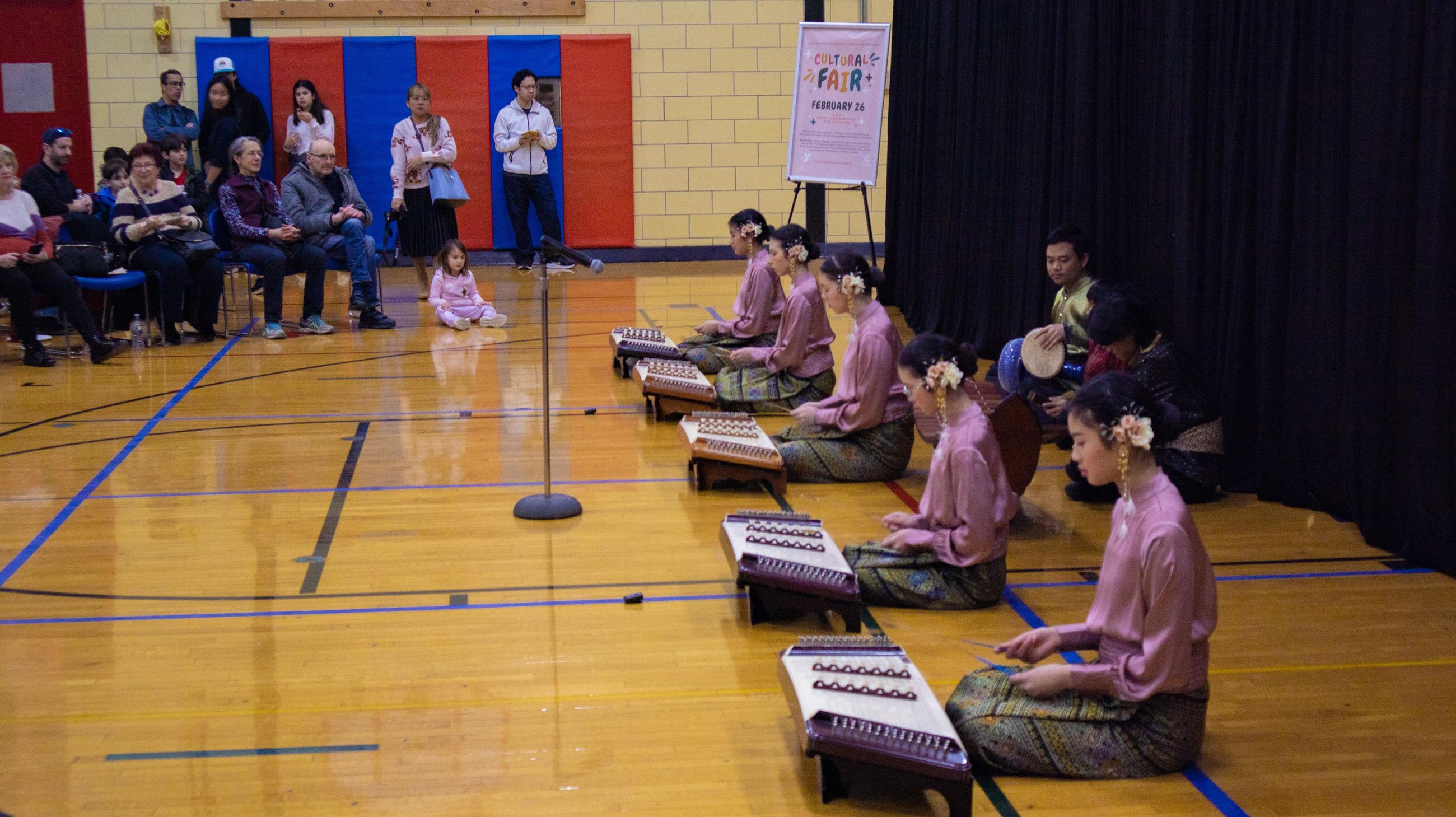 Cultural Fair - Thai Cultural Center performers knelt down playing music