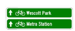 Green signs pointing to Wescott Park and Metra Station